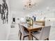Bright dining room with a chandelier, and seating for six, in an open concept space at 4907 21St W Ave, Bradenton, FL 34209