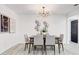 Dining area featuring contemporary chandelier, modern artwork, and seating for six at 4907 21St W Ave, Bradenton, FL 34209