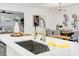 Open kitchen boasts a modern sink with gold fixtures, and a view of the dining area at 4907 21St W Ave, Bradenton, FL 34209