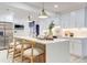 Bright, open kitchen featuring a center island with seating, white cabinetry, and stainless steel appliances at 4907 21St W Ave, Bradenton, FL 34209
