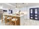 Modern kitchen boasts a large island with bar seating, new cabinets and fixtures, and bright natural light at 4907 21St W Ave, Bradenton, FL 34209