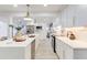 Well-lit kitchen showcasing an expansive center island with seating, and new cabinets and fixtures at 4907 21St W Ave, Bradenton, FL 34209