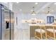 Updated kitchen showcasing a modern island with seating, stainless steel refrigerator, and stylish lighting at 4907 21St W Ave, Bradenton, FL 34209