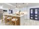 Modern kitchen boasts a large island with bar seating, new cabinets and fixtures, and bright natural light at 4907 21St W Ave, Bradenton, FL 34209