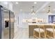 Updated kitchen showcasing a modern island with seating, stainless steel refrigerator, and stylish lighting at 4907 21St W Ave, Bradenton, FL 34209