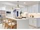 Bright, open kitchen featuring a center island with seating, white cabinetry, and stainless steel appliances at 4907 21St W Ave, Bradenton, FL 34209