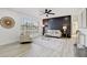 Bright, airy living room featuring a modern ceiling fan, stylish decor, and wood plank flooring at 4907 21St W Ave, Bradenton, FL 34209