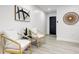 Living room featuring wood plank flooring, contemporary furniture and decor, and a painted black door at 4907 21St W Ave, Bradenton, FL 34209