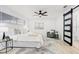 Inviting main bedroom with a ceiling fan and a sleek barn door to the bathroom at 4907 21St W Ave, Bradenton, FL 34209