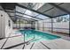 Indoor swimming pool with railing and covered patio at 4907 21St W Ave, Bradenton, FL 34209
