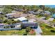 Aerial view of property with solar panels, backyard patio, fenced yard and lush landscaping at 3711 Huntington Ne St, St Petersburg, FL 33703