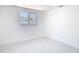 Sunlit bedroom with white walls, clean lines, tile floors, and a window overlooking the neighborhood at 3711 Huntington Ne St, St Petersburg, FL 33703