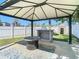 Covered patio features a fire pit, outdoor bar, and well-maintained lawn for outdoor entertaining at 3711 Huntington Ne St, St Petersburg, FL 33703