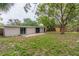 The backyard features lots of green space and is framed by a wooden fence at 4129 Highland Loop, New Port Richey, FL 34652