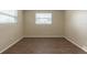 Bedroom features hardwood floors, natural light from windows and neutral colored walls at 4129 Highland Loop, New Port Richey, FL 34652