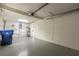 Spacious garage featuring a water heater, storage, and garage door opening system at 4129 Highland Loop, New Port Richey, FL 34652