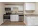 Updated kitchen featuring stainless steel appliances, granite countertops, ample cabinetry, and new floors at 4129 Highland Loop, New Port Richey, FL 34652