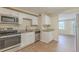 Modern kitchen featuring stainless steel appliances, new floors, plenty of cabinet space, and granite countertops at 4129 Highland Loop, New Port Richey, FL 34652
