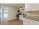 Well-lit kitchen featuring granite countertops, new cabinetry, stainless steel appliances, and new flooring at 4129 Highland Loop, New Port Richey, FL 34652