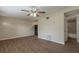 Bright living room features ceiling fan and wood-look floors for a modern touch at 4129 Highland Loop, New Port Richey, FL 34652