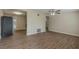 Open living room with new floors seamlessly connects to kitchen featuring stainless steel refrigerator and appliances at 4129 Highland Loop, New Port Richey, FL 34652