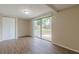 View of bright living room with hardwood floors and sliding glass doors to the backyard at 4129 Highland Loop, New Port Richey, FL 34652