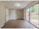 Bright living room with hardwood floors, closet and sliding glass doors to the backyard at 4129 Highland Loop, New Port Richey, FL 34652