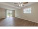 Bright living room with a ceiling fan, a window and sliding glass doors to the backyard at 4129 Highland Loop, New Port Richey, FL 34652