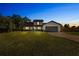 Charming two-story home at twilight with a well-manicured front lawn and mature landscaping at 5303 Glen Harwell Rd, Plant City, FL 33566