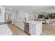 Open concept kitchen with stainless steel appliances and quartz countertops overlooking the living area at 5303 Glen Harwell Rd, Plant City, FL 33566