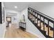 Bright foyer with a staircase featuring black railings and natural wood steps at 5303 Glen Harwell Rd, Plant City, FL 33566