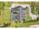 Aerial view showcasing a home with a screened-in pool, expansive roof, and a brick driveway at 1570 Oakford Rd, Sarasota, FL 34240