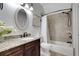 Bathroom featuring a granite countertop vanity and tile shower and tub at 1570 Oakford Rd, Sarasota, FL 34240