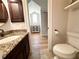 Elegant bathroom featuring a granite countertop vanity with tile flooring at 1570 Oakford Rd, Sarasota, FL 34240