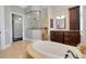 Luxurious bathroom features an oval tub, walk-in shower, and dark wood vanities at 1570 Oakford Rd, Sarasota, FL 34240