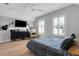 Cozy bedroom featuring a mounted TV, guitars and lots of bright, natural light at 1570 Oakford Rd, Sarasota, FL 34240