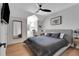 Charming bedroom featuring a spacious bed, ceiling fan and bright natural light at 1570 Oakford Rd, Sarasota, FL 34240