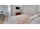 Cozy bedroom featuring hardwood floors, natural light, and stylish decor at 1570 Oakford Rd, Sarasota, FL 34240