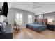 Comfortable bedroom featuring a large window, mounted TV and a bedside lamp at 1570 Oakford Rd, Sarasota, FL 34240