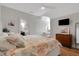 Well-lit bedroom with a view into vanity and bathroom, with hardwood flooring at 1570 Oakford Rd, Sarasota, FL 34240