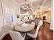 Inviting dining area with hardwood floors and open kitchen design for modern living at 1570 Oakford Rd, Sarasota, FL 34240
