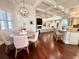 Open dining and kitchen area with coffered ceilings, modern lighting, and breakfast bar at 1570 Oakford Rd, Sarasota, FL 34240