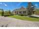 Charming single-story home featuring a well-manicured front yard with attractive landscaping and a brick paver driveway at 1570 Oakford Rd, Sarasota, FL 34240