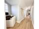 Bright hallway with hardwood floors, white walls, and natural light with a quaint office nook at 1570 Oakford Rd, Sarasota, FL 34240