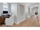 Bright hallway with hardwood floors leading to a built-in desk area at 1570 Oakford Rd, Sarasota, FL 34240