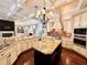 Open kitchen featuring granite countertops, an island, stainless appliances, and brick backsplash at 1570 Oakford Rd, Sarasota, FL 34240