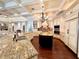 Bright kitchen showcasing a large island with granite countertops, stainless appliances, and custom cabinets at 1570 Oakford Rd, Sarasota, FL 34240