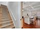 Stairway leading to a modern kitchen with a large island and bar seating at 1570 Oakford Rd, Sarasota, FL 34240