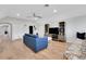 Bright living room with hardwood floors, built-in shelves, and a comfortable blue sofa at 1570 Oakford Rd, Sarasota, FL 34240