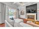 Relaxing living room with fireplace and sliding glass doors to the pool at 1570 Oakford Rd, Sarasota, FL 34240